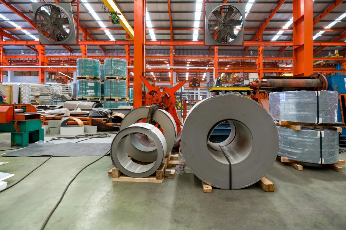 Steel coils and sections staged at a Chinese steel warehouse ready for export loading